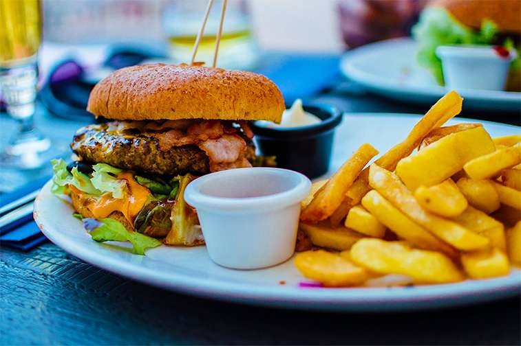 unhealthy diets - hamburger and fried potatoes